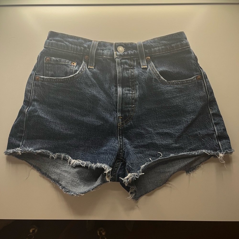 Dark wash, distressed Levi 501 shorts.